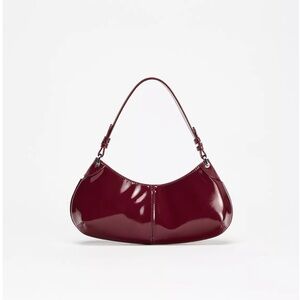 Faux patent leather finish shoulder bag.